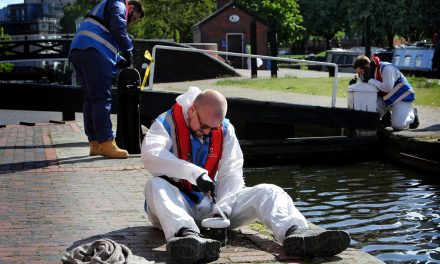 GMI Construction Group volunteers restore metalwork on canal lock gates